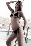 Awesome babe in black bikini demonstrates her body