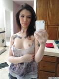 Tattooed brunette babe Indigo August taking selfies of shaved pussy