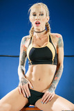 Tattooed female wrestler Sarah Jessie exposes her big tits and sexy tight body