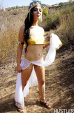 Brunette chick Aimee Black slips off exotic attire on a dirt path in the hills