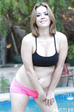 Pornstar Sierra Sanders freeing juicy ass from pink panties by swimming pool